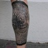 Engraving style black ink leg tattoo of crossed section of the tree