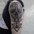 Engraving style black ink shoulder tattoo of human skull with butterfly