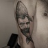 Engraving style black ink shoulder tattoo of big whale stylized with man face