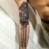 Engraving style black ink sleeve tattoo of tall trees