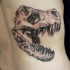 Engraving style black ink thigh tattoo of dinosaur skull