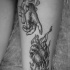 Engraving style black ink thigh tattoo of human hands with heart