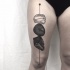 Engraving style black ink thigh tattoo of various stones