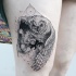 Engraving style black ink thigh tattoo of owl with solar system