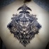 Engraving style black ink upper back tattoo of mystical face with birds and mushrooms