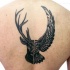Engraving style colored back tattoo of deer with flying owl