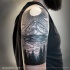 Engraving style colored shoulder tattoo of mountain with lake and forest