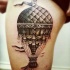 Engraving style colored thigh tattoo fo flying balloon