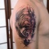 Engraving style colored tiger tattoo on shoulder