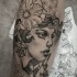 Engraving style detailed arm tattoo of woman face with flowers