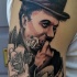 Engraving style half colored shoulder tattoo of Charlie Chaplin with roses