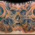 Fantastic colored chest tattoo of human skull with alien flowers