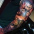 Fantastic multicolored sleeve tattoo of various superheroes portraits