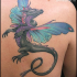Fantasy like colored shoulder tattoo of dragon with fairy wings