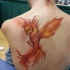 Fiery phoenix tattoo on back for women by sarah miller