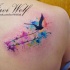 Flying black bird with lettering and colored paint drips in watercolor style shoulder blade tattoo by Javi Wolf