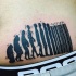 Funny looking black ink belly tattoo of human like barcode
