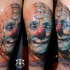 Funny looking colored crazy clown tattoo