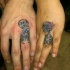 Funny man and woman skeleton romantic couple colored tattoos on ring fingers
