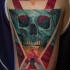 Geometrical style colored shoulder tattoo of triangles and skull