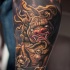 Golden dragon tattoo on leg