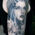 Gray washed style colored shoulder tattoo of woman with various ornaments