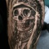 Gray washed style detailed biceps tattoo of Indian skeleton