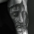 Gray washed style detailed Jesus portrait tattoo on biceps