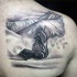 Gray washed style scapular tattoo of snowboarder with mountains