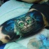 Tatuaje en el brazo, gato adorable de Cheshire, dibujo impresionante