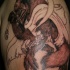Half colored shoulder tattoo of illustrative werewolf