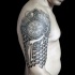 Half geometric half ornamental style tattoo on shoulder