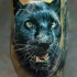 Tatuaje en la pierna de una cabeza negra de pantera.