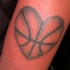 Heart shaped colored shoulder tattoo of ball