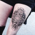 Hinduism style black ink arm tattoo of beautiful flower