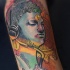 Hinduism themed colored tattoo of Buddha statue with ornaments