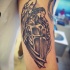 Homemade black ink holy angel warrior tattoo on biceps