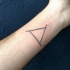 Homemade like black ink interesting triangle shaped symbol tattoo on wrist