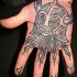 Homemade simple black ink carelessly painted hand tattoo of evil antic warrior