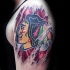 Homemade style colored shoulder tattoo of Indian picture under skull