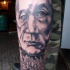 Homemade style detailed leg tattoo of old man portrait