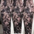 Horror style black ink forearm tattoo of zombie woman with burning church
