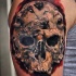 Horror style colored shoulder tattoo of human skull with monster faces