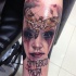 Horror style creepy looking arm tattoo of demon woman with butterfly