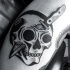 Illustrative style black ink human skull with knife