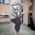 Illustrative style black ink leg tattoo of deer head