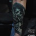 Illustrative style colored arm tattoo of Grimm reaper with cards