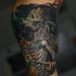 Illustrative style colored arm tattoo of fantasy evil skeleton king