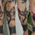 Illustrative style colored arm tattoo of flying bird with tree house