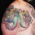 Illustrative style colored chest and shoulder tattoo of cool octopus